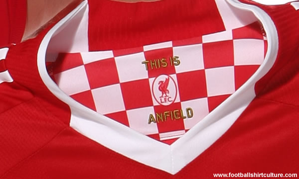 An embroidered Liver Bird is positioned on the back of the shirt and the inner neck of the shirt has a red chequered area inspired by the flags of The Kop.
