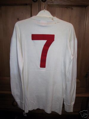 It is a white round collared Umbro no 7 number shirt. It is a white round collared Umbro no 7 number shirt.
