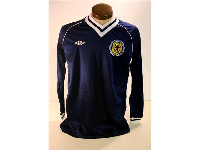 318. Scotland International Shirt: A blue with white trim V-neck shirt with embroidered badge to front, No 16 to rear. £250-300 318. Scotland International Shirt: A blue with white trim V-neck shirt with embroidered badge to front, No 16 to rear. £250-300
