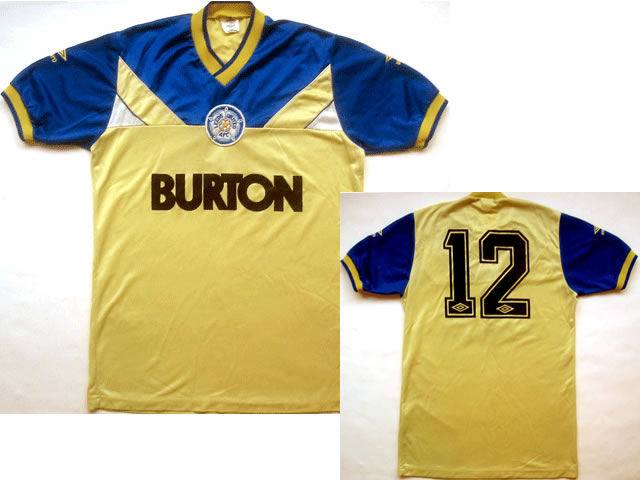 Embroidered Umbro logos, stitched club badge, heat pressed Umbro players No.12. The first Leeds shirt to bear the classic Burton sponsor, worn when Billy Bremner was manager Embroidered Umbro logos, stitched club badge, heat pressed Umbro players No.12. The first Leeds shirt to bear the classic Burton sponsor, worn when Billy Bremner was manager